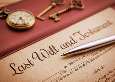A document titled Last Will and Testament with a pen on top - Legacy Law Centers