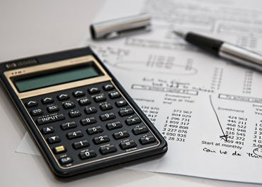 IRS Gift Taxes concept with calculator, tax form & pen - Legacy Law Centers