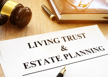 Legal documents titled Living Trust & Estate Planning on a table with a gavel and pen - Legacy Law Centers