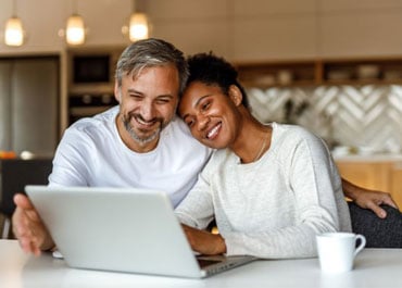 Couple discussing Estate Planning matters, woman leaning on man's shoulder