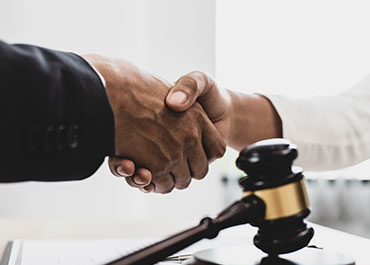 Handshake over a gavel, highlighting common myths about Virginia business succession planning in Loudoun County.